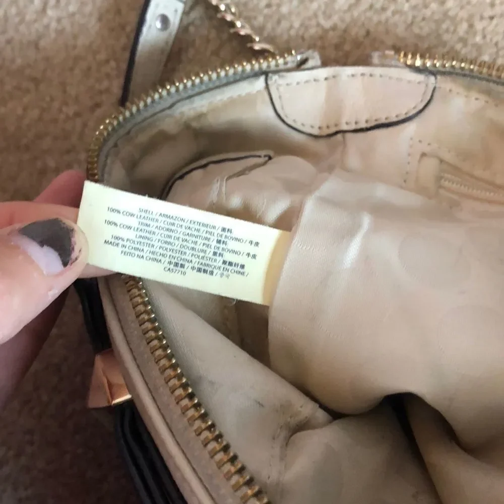 Kate Spade cream purse with a black bow